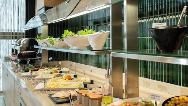 A buffet with various food items and condiments. - ALVES HOTEL (İzmir)