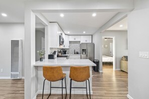 Dishwasher, coffee/tea maker, cookware/dishes/utensils, dining tables