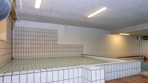 A tiled swimming pool with a tiled floor and walls, surrounded by a tiled deck area. - 4 Person Holiday Park Home in Glesborg (Glesborg)