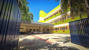 A building named "LUNA CASTLE" with a parking area and a gated entrance. - Luna Castle (Palayankottai)