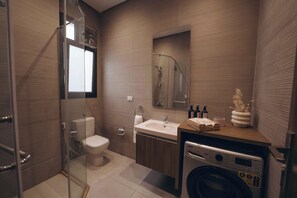 Separate bathtub and shower, towels, soap, shampoo