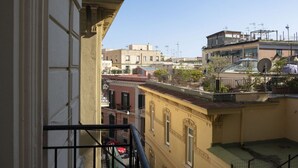 A residential building with balconies, a clear sky, and neighboring structures. - Room Giulia By Dimorra (Napoli)
