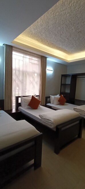 Deluxe Triple Room, Balcony, Garden View | Desk, laptop workspace, blackout drapes, soundproofing
