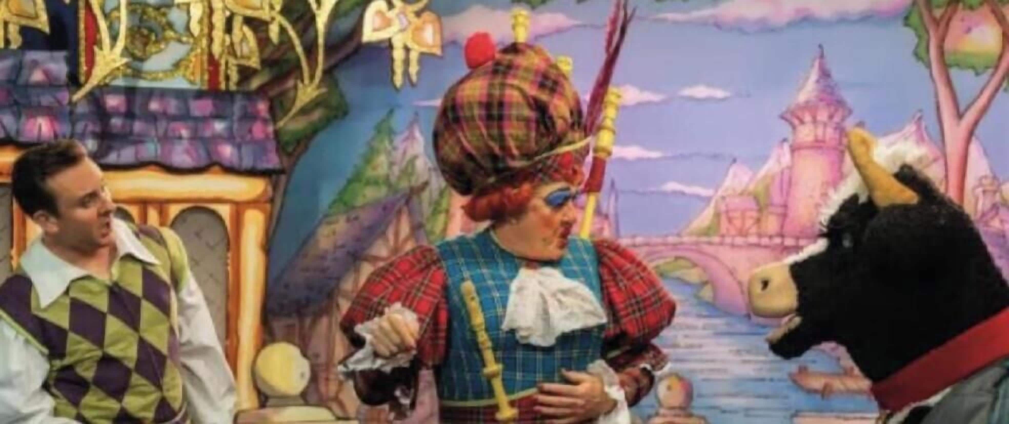 A person in a plaid outfit with a sword, a horse, and a castle-like background.