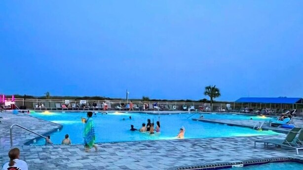 A large outdoor swimming pool with multiple lanes and a separate shallow area for children. - Blue Lagoon - Hhbt Resort 2 Bedroom Villa (Hilton Head Island)