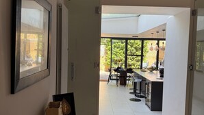 A modern kitchen with a dining area, a large window, and a view of the outdoors. - Contemprary central London 5 bed townhouse (London)