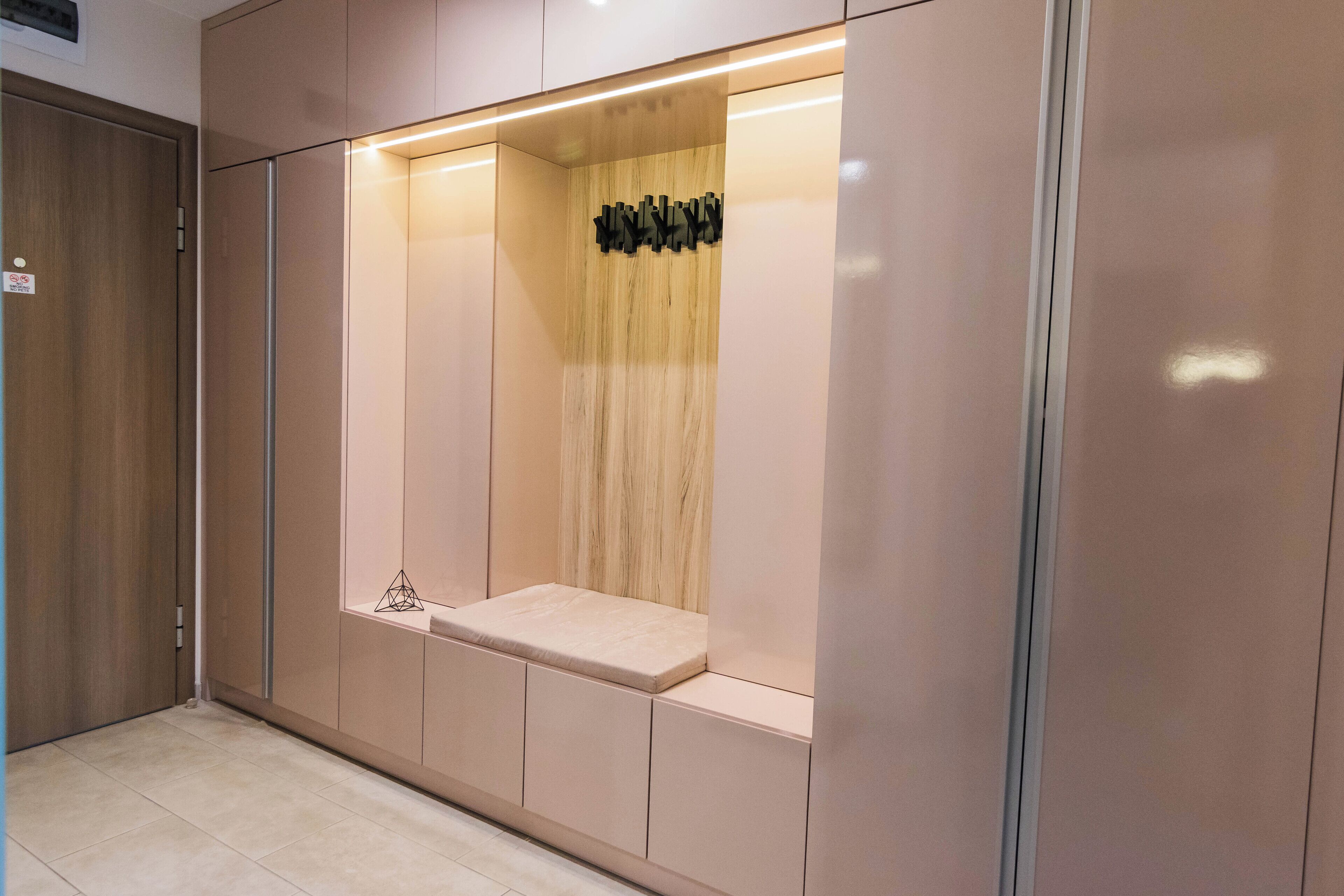 A modern room with a built-in seating area, a wooden accent wall, and a minimalist design.