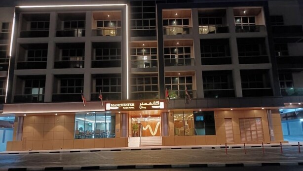 A multi-story hotel with a modern facade, multiple balconies, and a well-lit entrance. - Imperiaa by HOC Globe (Dubai)
