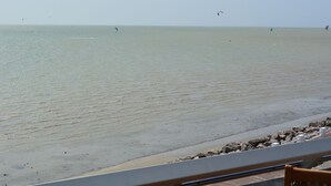 A beach with a sandy shore and a rocky breakwater.