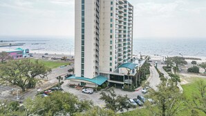 A high-rise hotel with a curved roof, located near a beach with a view of the ocean. - Ocean Club 408 | Enjoy Views of the Gulf! (Biloxi)