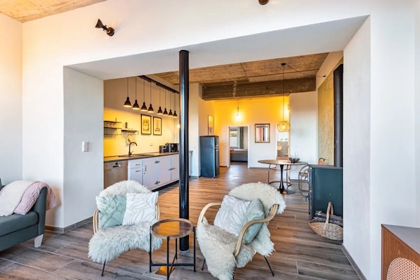 A modern interior with a kitchen, dining area, and seating space.