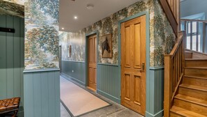 A hallway with wooden doors, a bench, and a staircase. - Greenstyle  - Countryside retreat with castle views (Kildrummy)