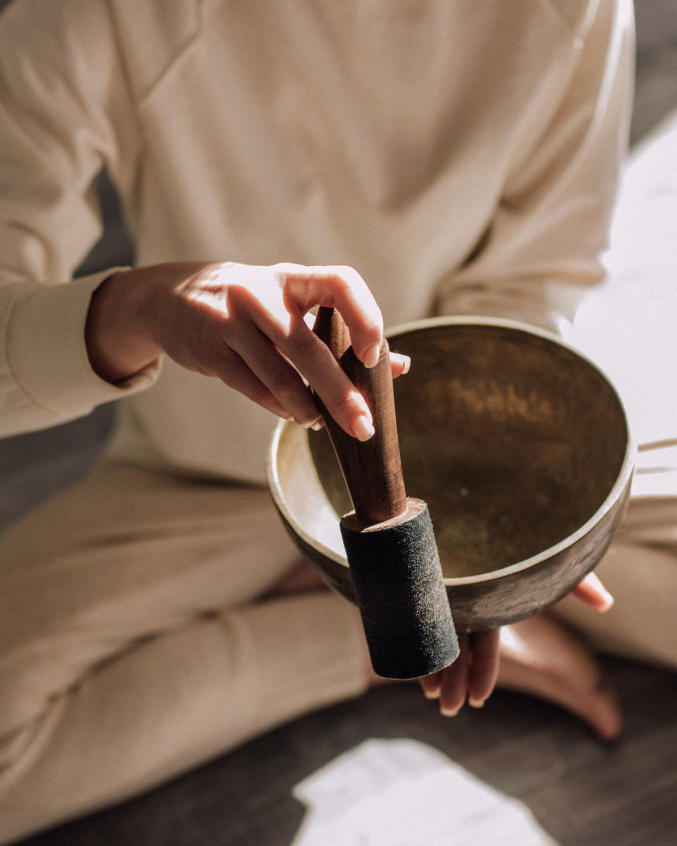 A person holding a meditation bowl.