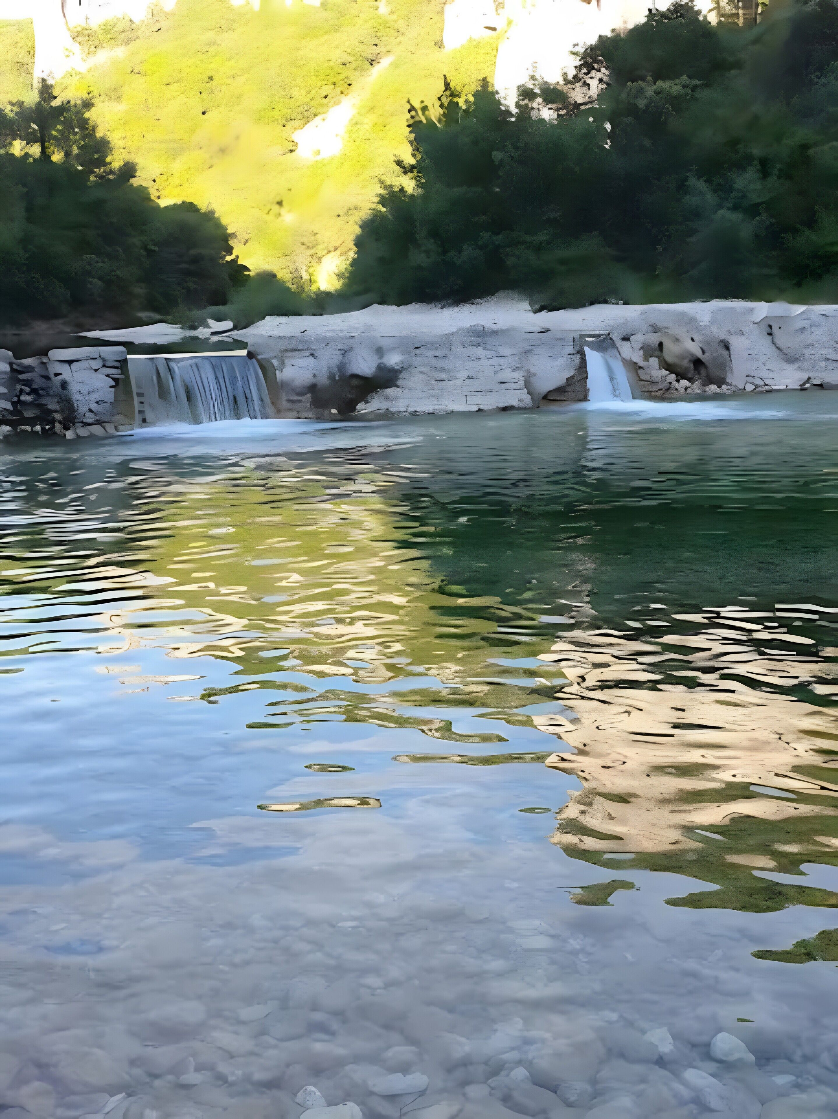 A natural landscape with a waterfall, clear water, and surrounding greenery.