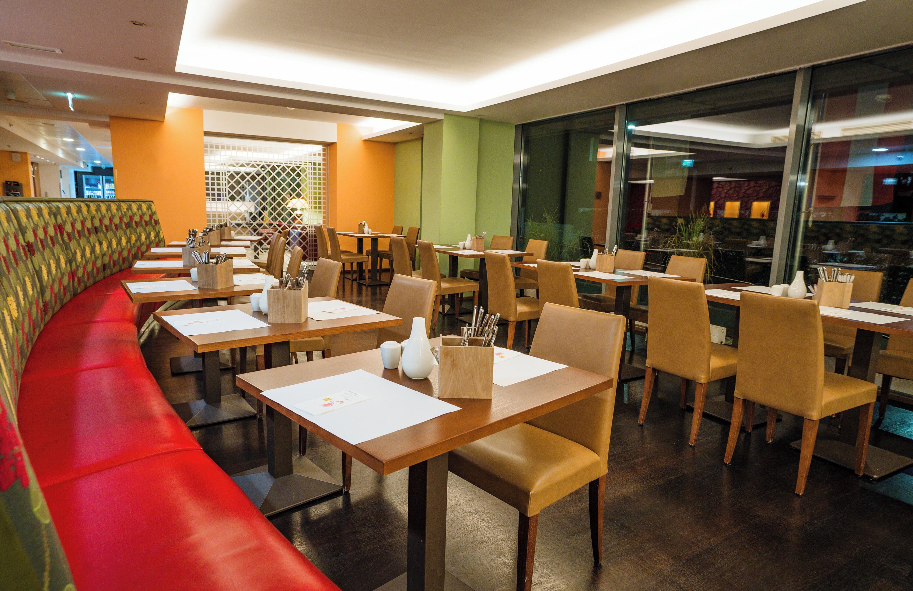 A restaurant with booths, tables, and chairs.