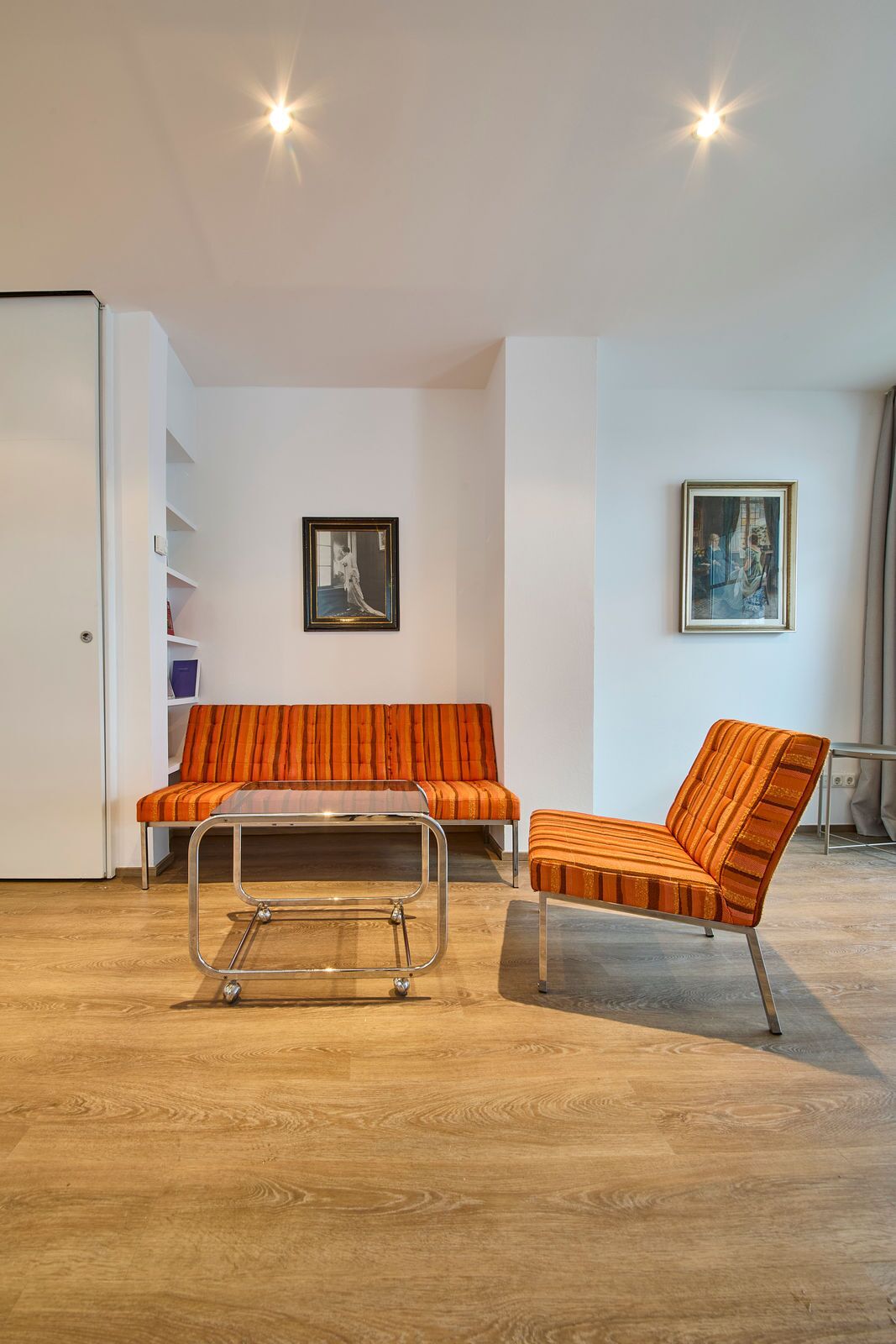 A modern living room with a sofa, a chair, and a coffee table.