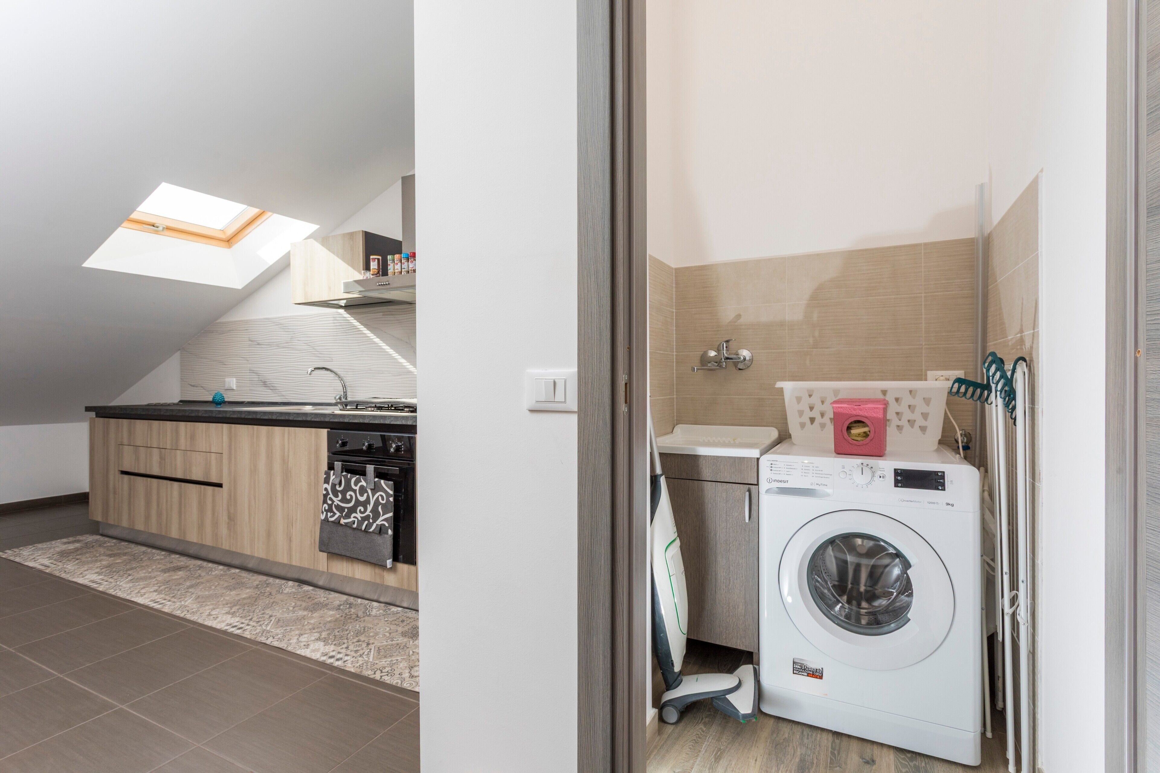 A modern kitchen with a skylight, a built-in oven, and a countertop.