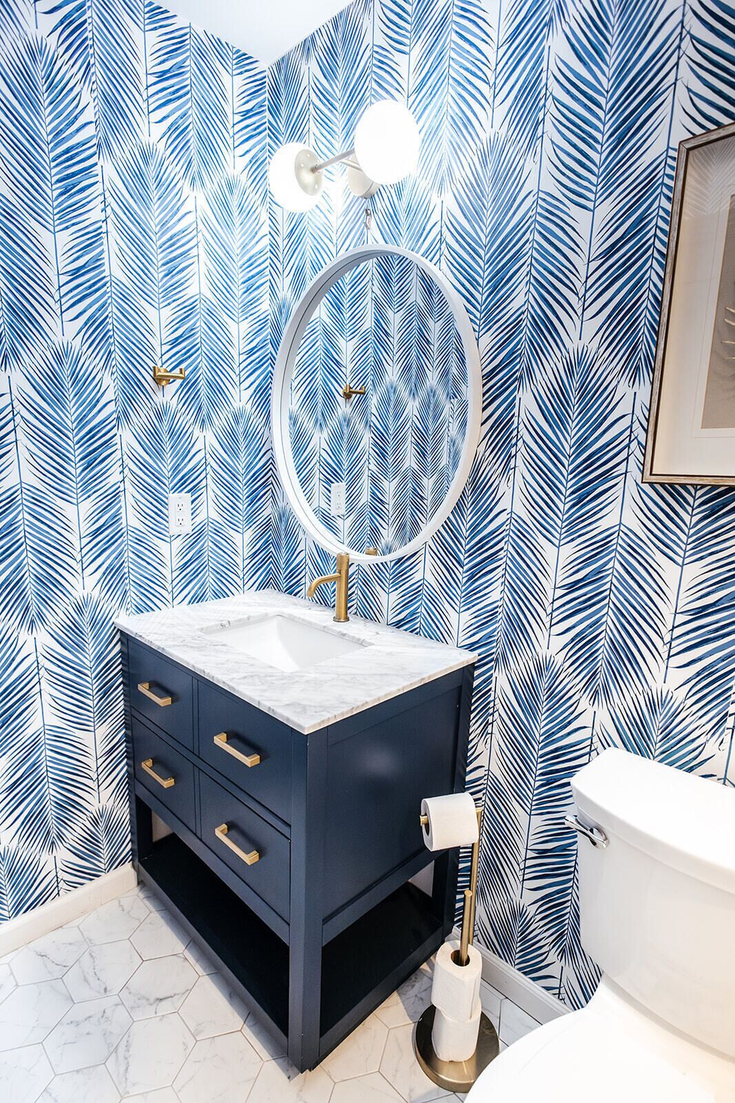 A bathroom with a vanity, a mirror, and a toilet.