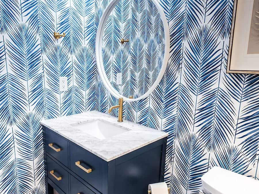 A bathroom with a vanity, a mirror, and a toilet.