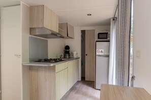 Fridge, microwave, coffee/tea maker, cookware/dishes/utensils