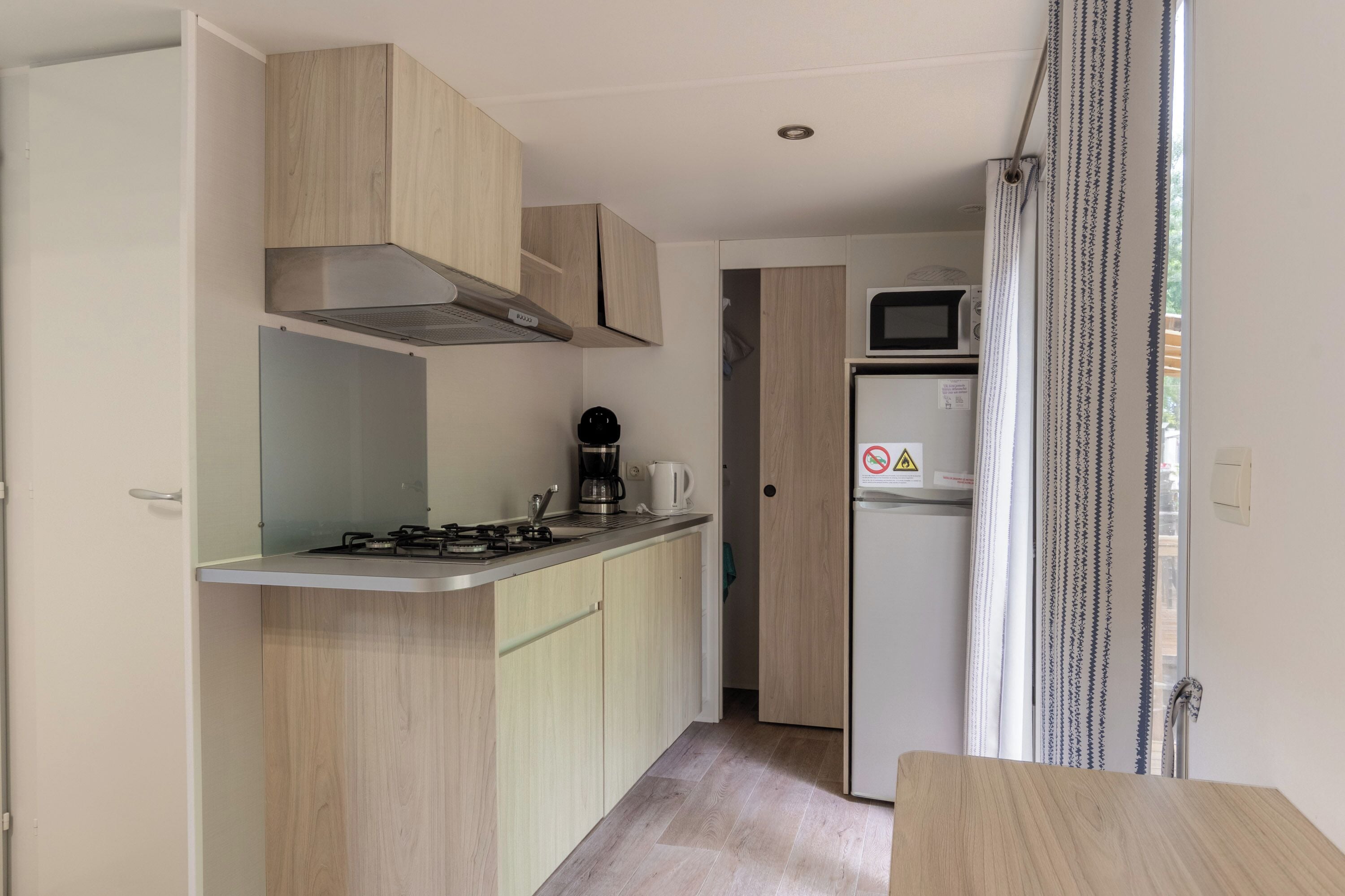 Fridge, microwave, coffee/tea maker, cookware/dishes/utensils