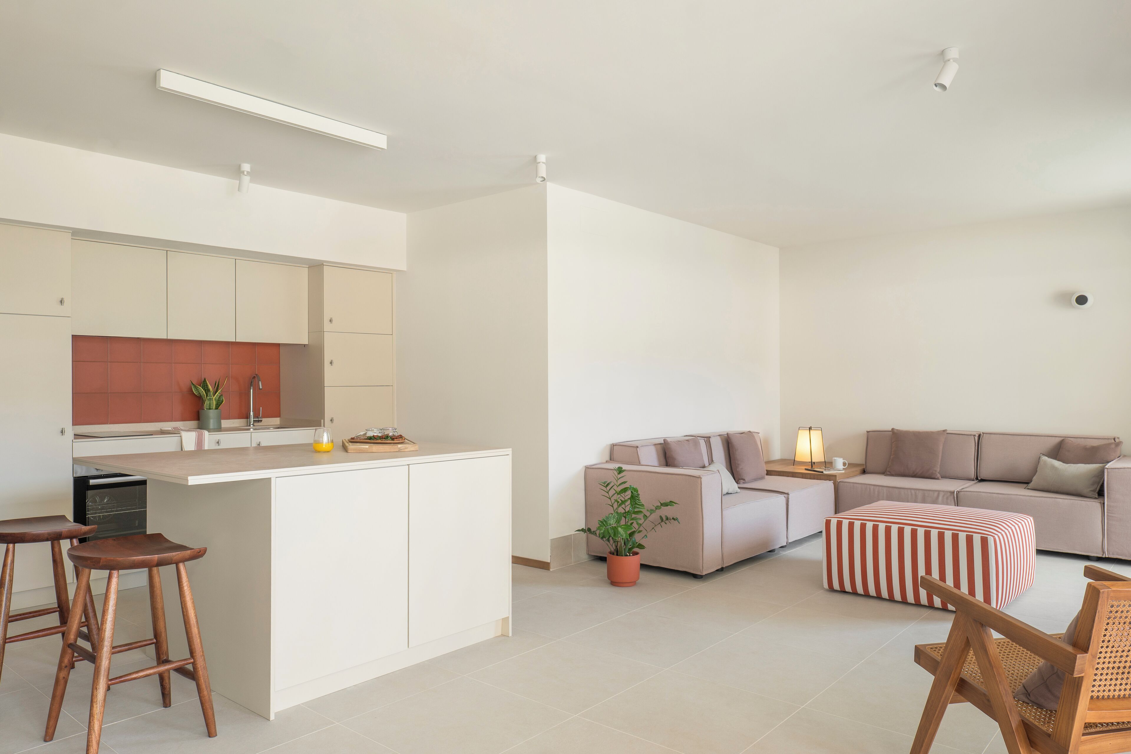 A modern apartment with a kitchen, living area, and a small dining space.