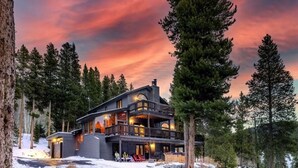 A large, two-story lodge with a balcony and a fireplace, surrounded by tall pine trees. - Spacious 5BR Breckenridge Cabin, Game Room, Hot Tub, Minutes to Breck Ski Resort (Breckenridge)