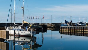 A marina with boats docked, a wooden pier, and a clear sky. - 6 Person Holiday Park Home in Glesborg (Glesborg)