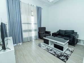 A modern living room with a sofa, armchair, and coffee table.
