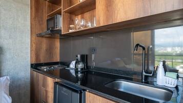 Fridge, microwave, coffee/tea maker, cookware/dishes/utensils