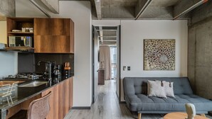 A modern kitchen with wooden cabinets, a black countertop, and a built-in microwave.