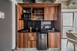 Fridge, microwave, coffee/tea maker, cookware/dishes/utensils