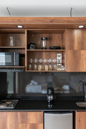 Fridge, microwave, coffee/tea maker, cookware/dishes/utensils