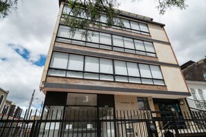 A multi-story building with large windows and a sign reading "ATARDECER 57". - Urban Loft @Chapinero near Campin Stadium (Bogotá)