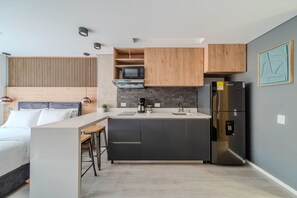 Fridge, microwave, coffee/tea maker, cookware/dishes/utensils