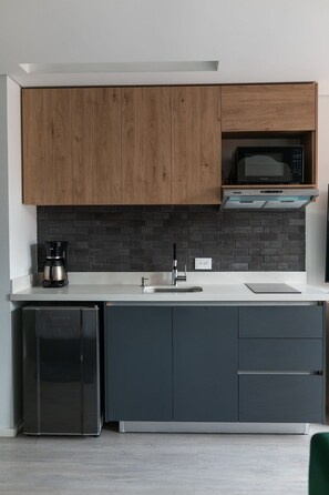 Fridge, microwave, coffee/tea maker, cookware/dishes/utensils