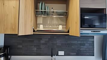 Fridge, microwave, coffee/tea maker, cookware/dishes/utensils