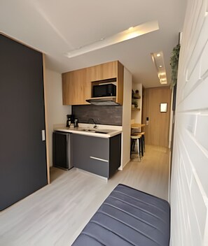 Fridge, microwave, coffee/tea maker, cookware/dishes/utensils