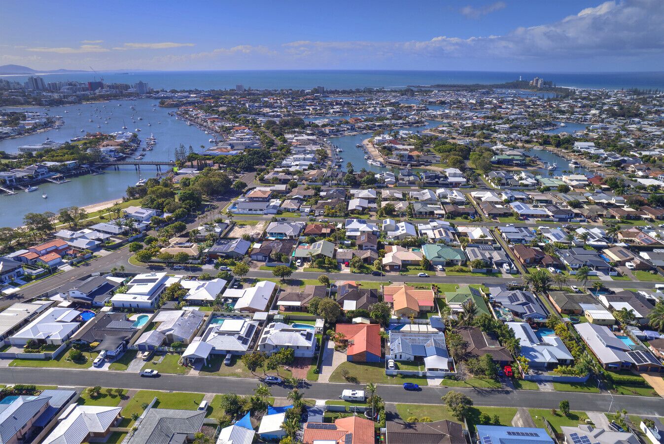 A residential area with houses, streets, and a marina with boats.