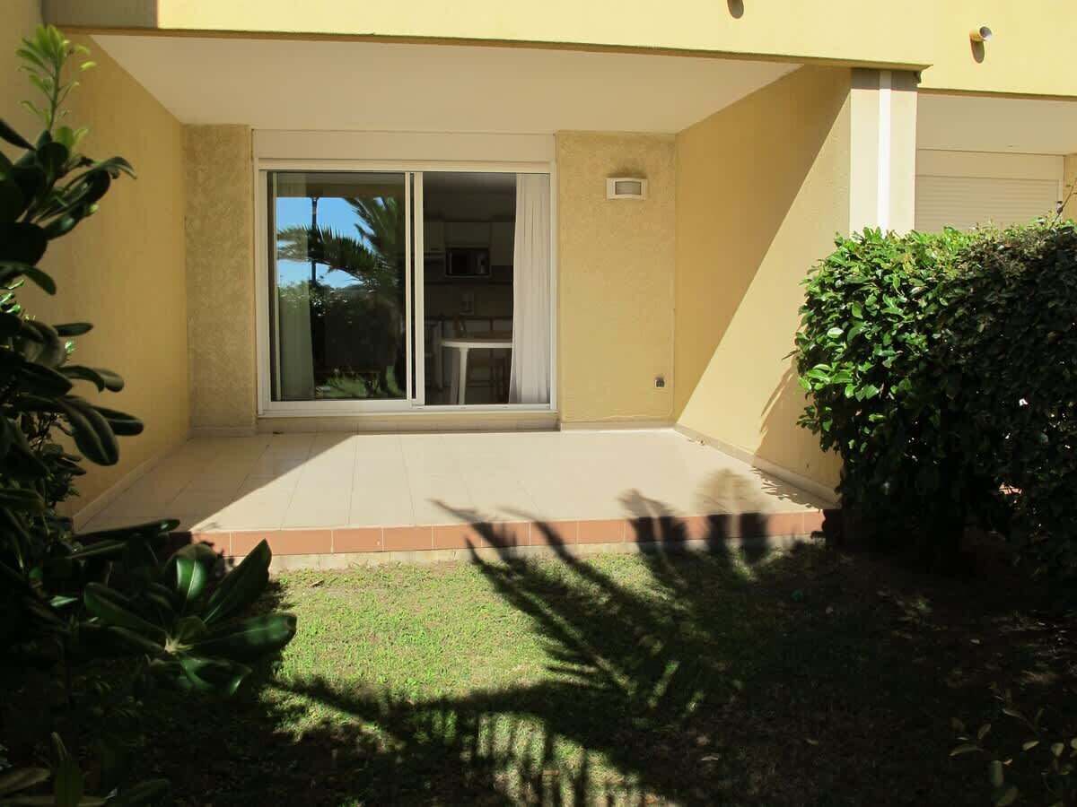A house with a sliding glass door leading to a covered patio area.
