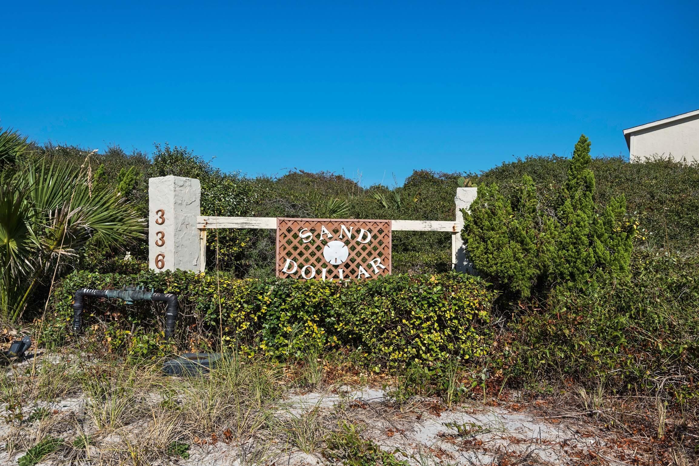 A sign with the number 336 and the text "SAND DOLLAR" in a desert setting.