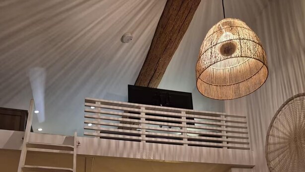 A cozy room with a bunk bed, a ladder, a sofa, a chair, a table, and a hanging light fixture. - Le Cosy Antibois - Proche Marché Provençal (Antibes)