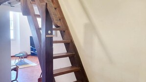 A wooden staircase with a simple design, leading to an upper floor.
