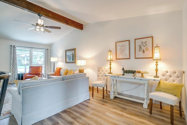 A living room with a sofa, chairs, a table, and a ceiling fan. - Robin House with two master suites! (Burleson)