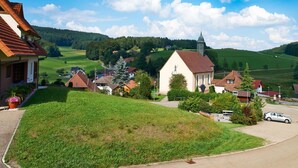 A rural village with a church, houses, and green fields. - Holiday Apartment 'Landblick' with Balcony and Wi-Fi (Biederbach)