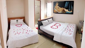 Two single beds with white linens and heart-shaped flower arrangements. - Ban Mai Hotel 66 (Phu Thuy)