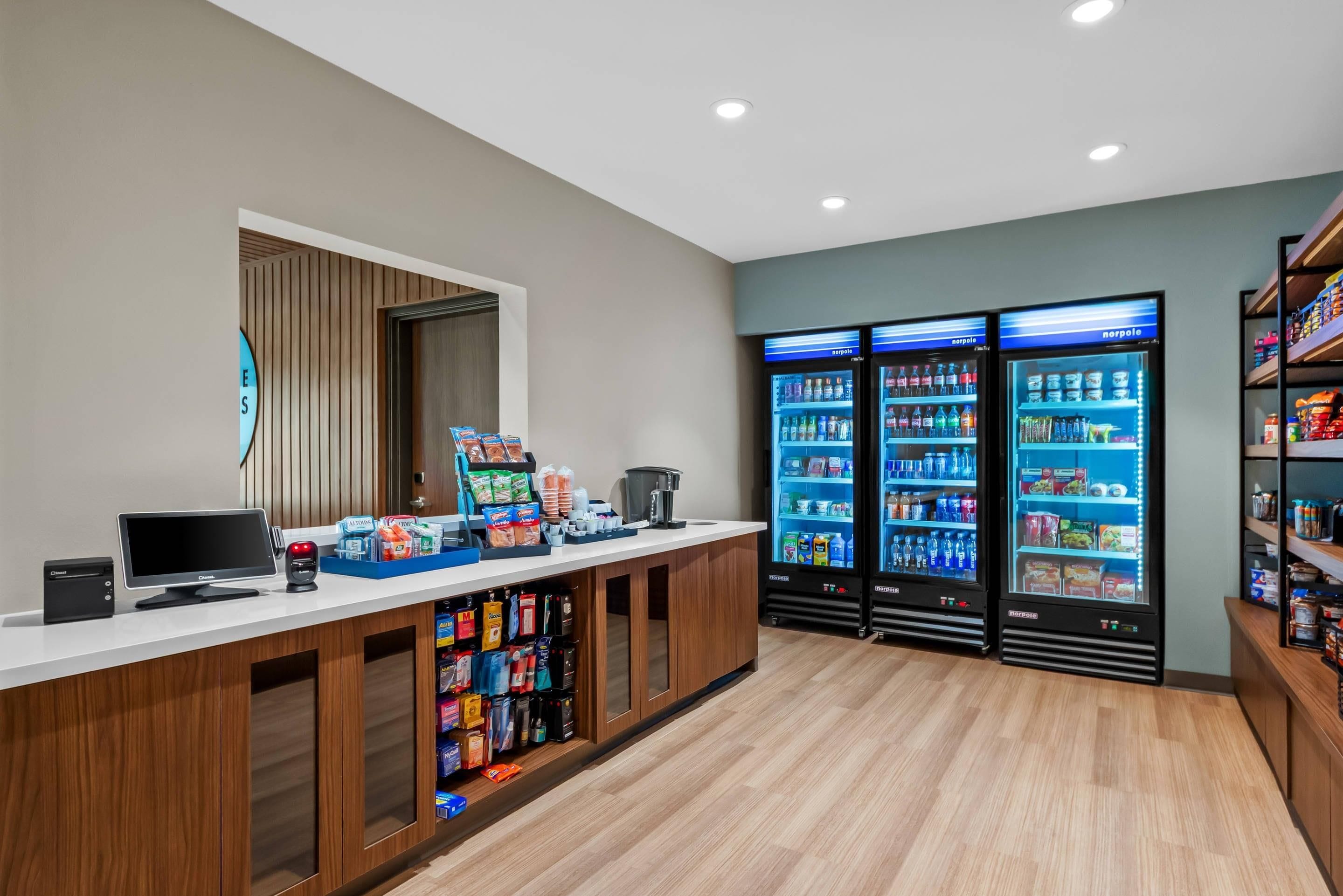 A reception area with a counter, computer, and vending machines.