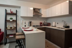 Fridge, microwave, stovetop, coffee/tea maker
