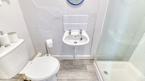Ein Badezimmer mit Toilette, Waschbecken und Dusche.