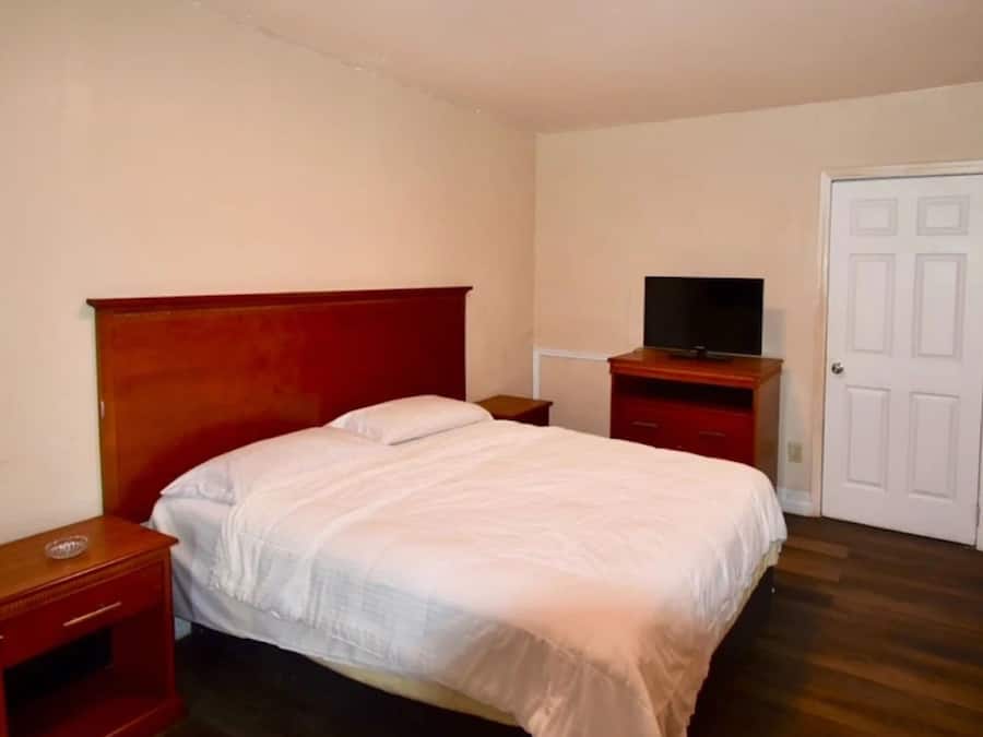 Room, 2 Queen Beds, Smoking | In-room safe, iron/ironing board, free WiFi, bed sheets